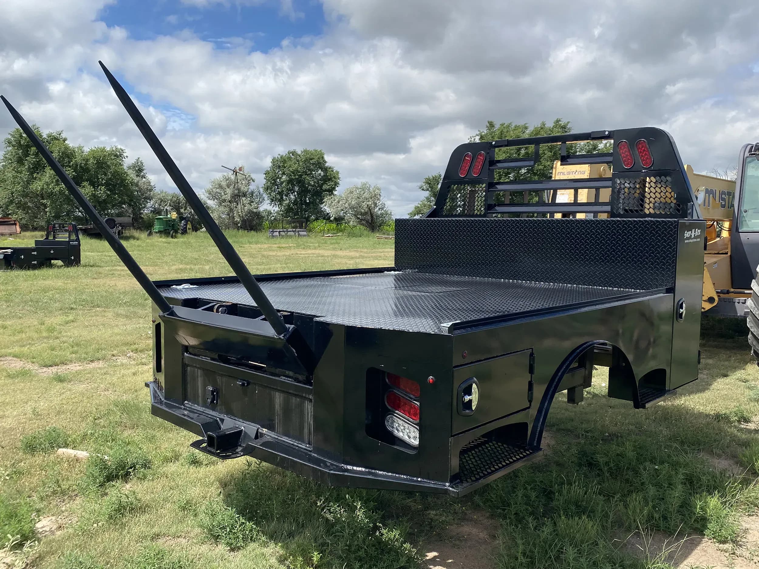 Shop-N-Box™ Hay Spike flatbed with integrated roll-out toolbox storage and tool organization inserts