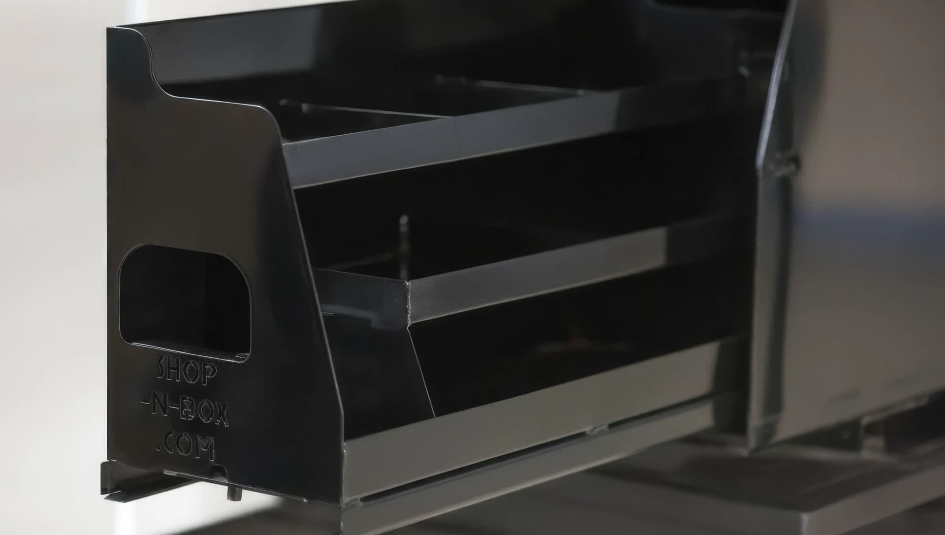 Shop-N-Box™ patented roller system close-up showing heavy-duty rollers on 10-gauge steel roll-out floor