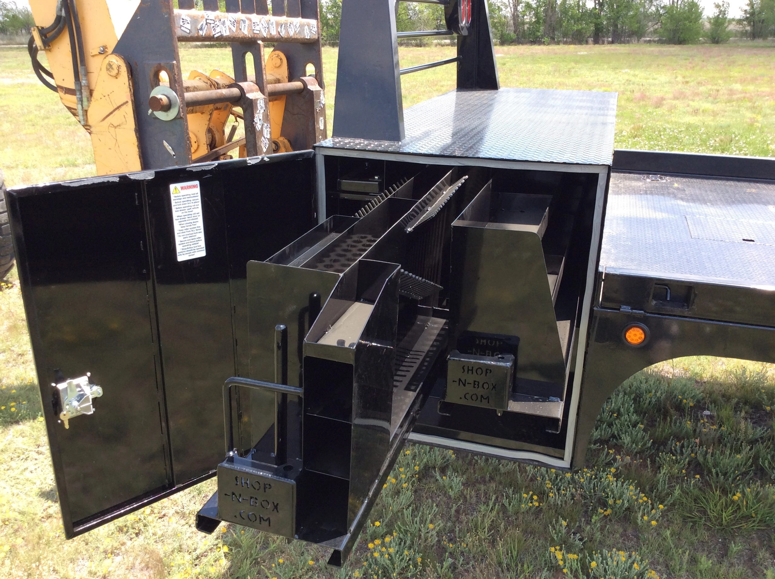 Shop-N-Box Generation 1 flatbed with corner tie-downs and ladder rack