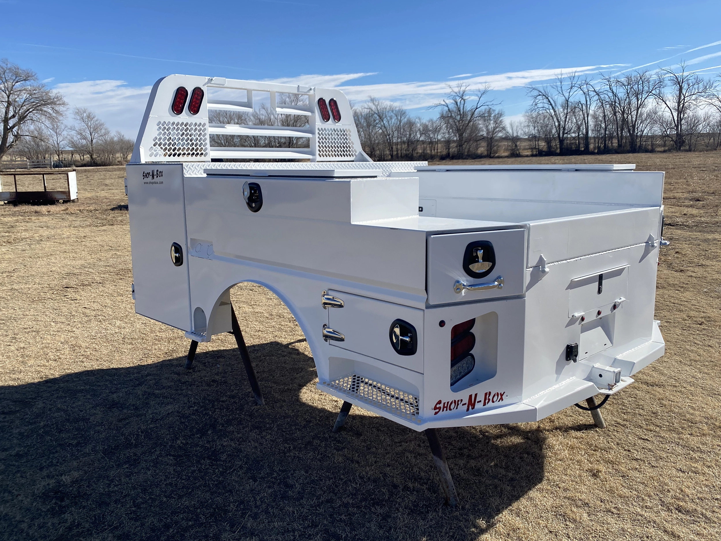 Shop-N-Box Legend Bed white finish outdoor showing rear center drawer and ventilation